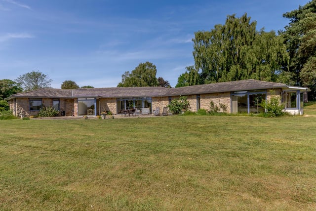 The bungalow is positioned at the end of a long tree-lined driveway and sits almost directly in the middle of just under one and a half acres of land, which is completely surrounded by nothing but open fields.