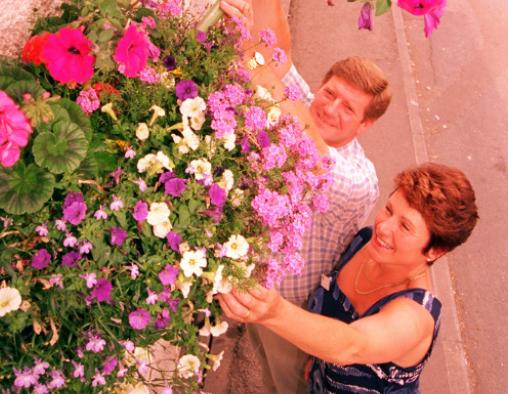 Adwick Postmaster and mistress, Barry and Daphne Hogg, tended to a hanging basket in 1996