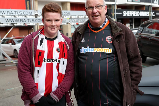 Two United supporters arrive for the League One clash with Northampton Town at Bramall Lane on New Year's Eve.