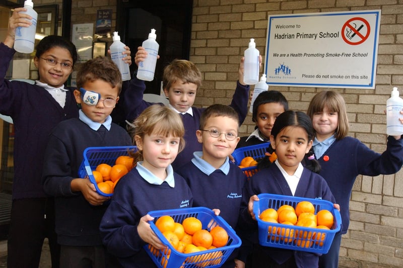 Pupils were pictured with their daily portions of fresh fruit and water in this photo from 18 years ago. Is there someone you know in this photo?
