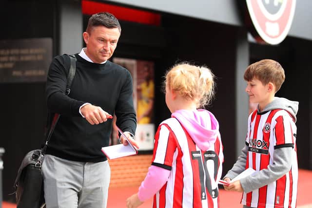 Paul Heckingbottom, the manager of Sheffield United, signs an autograph for a young fan: Lexy Illsley / Sportimage