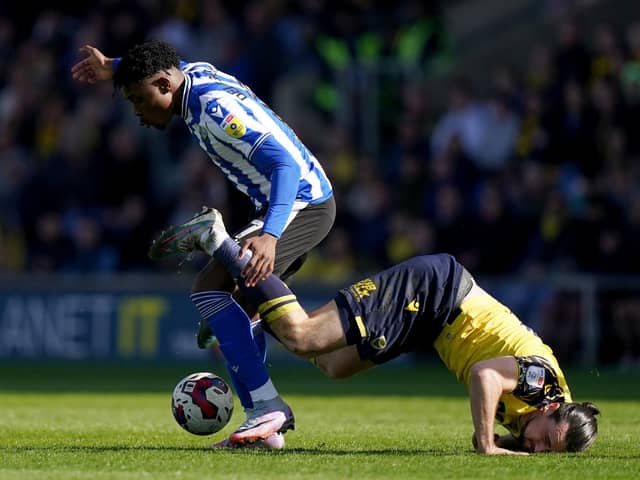 Sheffield Wednesday’s Fisayo Dele-Bashiru battles for the ball with Oxford United’s Ciaron Brown  during the Sky Bet League One match at the Kassam Stadium, Oxford. Picture date: Friday April 7, 2023. PA Photo. See PA story SOCCER Oxford. Photo credit should read: Adam Davy/PA Wire.

RESTRICTIONS: EDITORIAL USE ONLY No use with unauthorised audio, video, data, fixture lists, club/league logos or "live" services. Online in-match use limited to 120 images, no video emulation. No use in betting, games or single club/league/player publications.