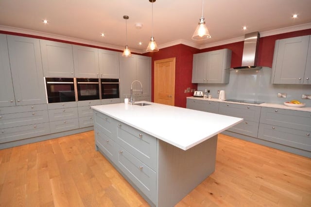 The kitchen offers remarkable fitted storage, central island unit, quartz work-tops and a full complement of integral appliances including induction hob, double oven, microwave, dishwasher, fridge, freezer and warming drawers.