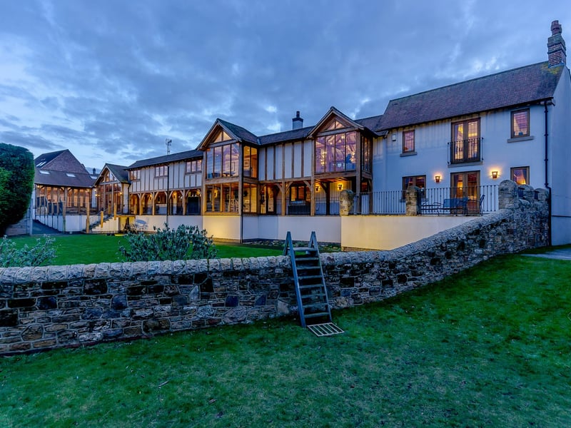 The property has lovely gardens with several renovated outbuildings, including a workshop and range of stores
