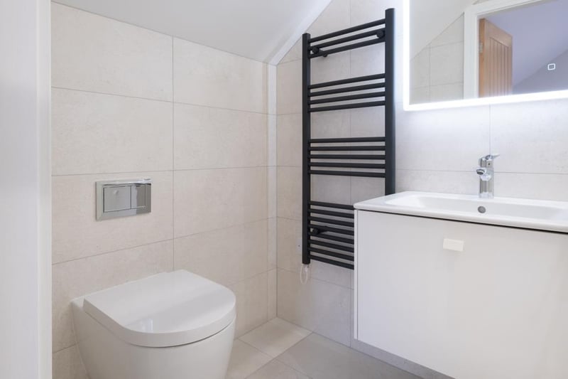 Being fully tiled and having recessed lighting, extractor fan and a powder-coated aluminium heated towel rail. There’s a Duravit suite in white.