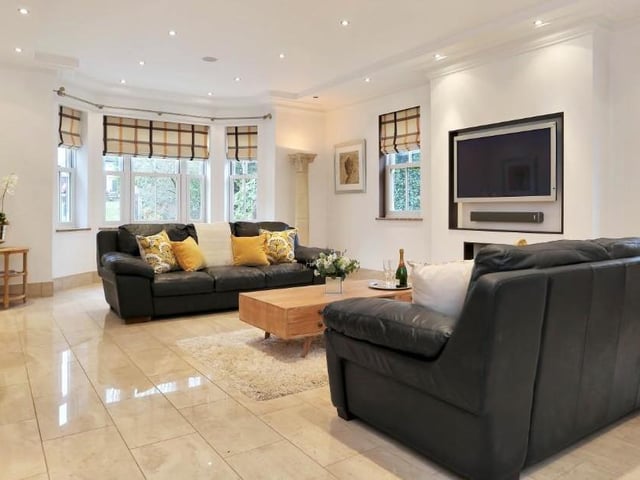 Time now to take a look at the oh-so-comfortable sitting room, which affords lots of natural light, thanks to a range of windows. It is also wired for surround sound.