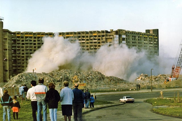 Onlookers watch as a wing of Sheffield's Hyde Park flats is demolished on March 2, 1992