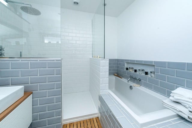 The main bathroom is tastefully tiled and contains a bathtub and a shower with a rain head fitting.