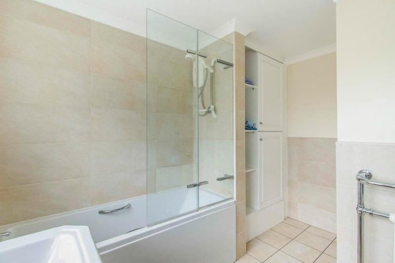 Fitted with a WC, a wash hand basin and a panel bath with shower over. There is a side facing obscure double glazed window, built in storage cupboard which houses the gas central heating boiler, tiling to the walls and floor and a central heating radiator.