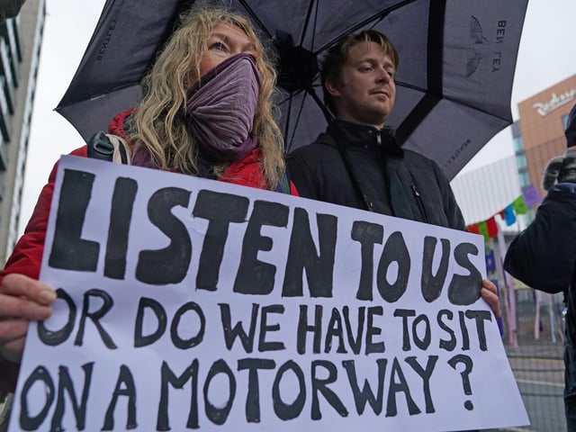 Climate Justice Activists at the Cop26 Gates asking delegates as they make final decisions, "Are You With Us Or With Fossil Fuels?" during the official final day of the Cop26 summit in Glasgow. Picture date: Friday November 12, 2021.
