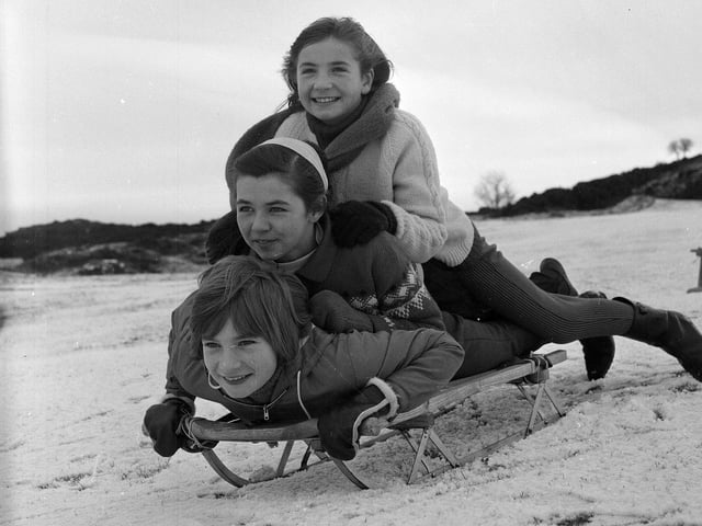 Three girls sledging on the Braid Hills in Edinburgh, November 1964.