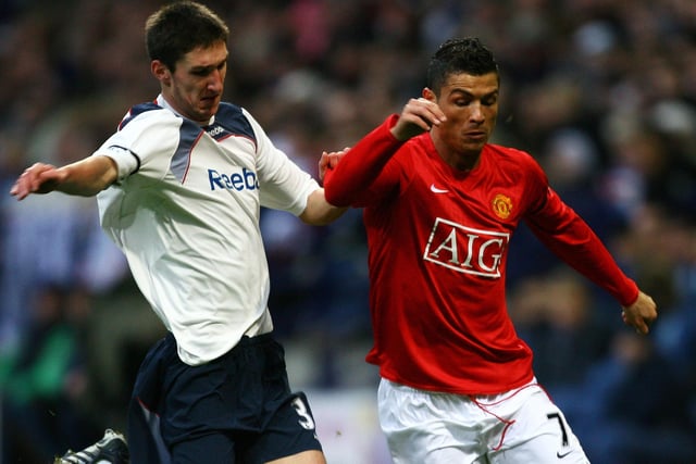 Chris Basham of Bolton battles with Cristiano Ronaldo of Manchester United