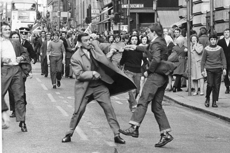 Detective Inspector George Johnstone cigarette in mouth, a special branch detective is slashed by a youth with an open razor in Renfield Street Glasgow  during a pro IRA march in 1971.