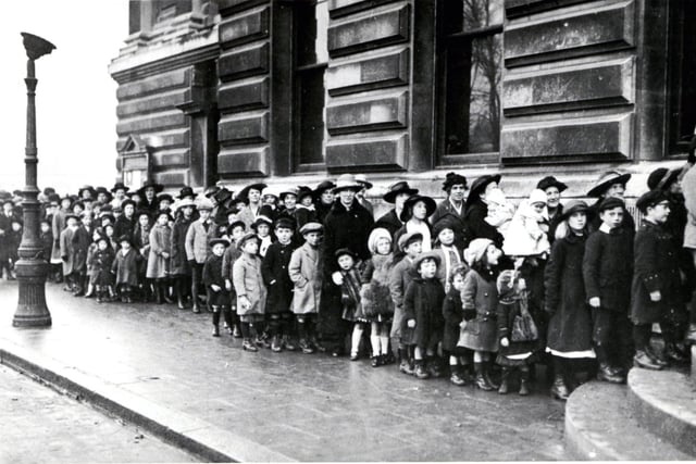 Fatherless children queue at Portsmouth Town Hall for a charity event at the end of the First World War