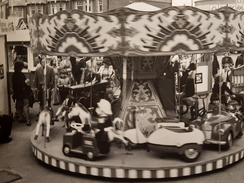 This scene shows the children's fairground opposite Olympia, Kiddies Corner. It is undated but probably mid-1980s