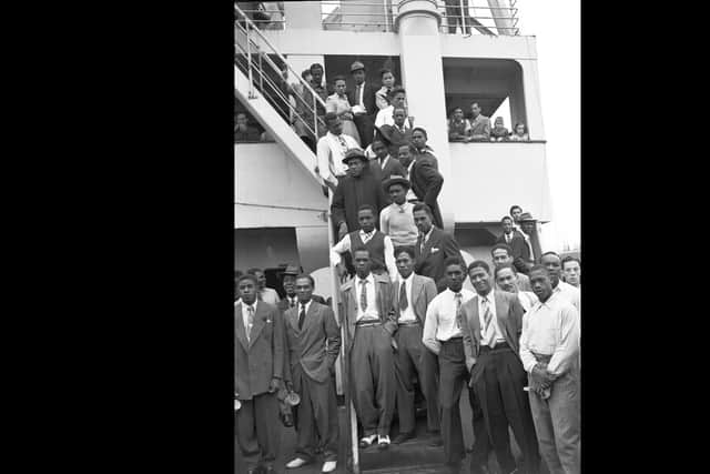 In this June 22, 1948 file photo, Jamaican men, mostly ex Royal Air Force servicemen, pose for a photo aboard the former troopship, S.S. Empire Windrush, before disembarking at Tilbury Docks, England. Monday, June 22, 2020 marks the 72nd anniversary since the Empire Windrush ship brought hundreds of Caribbean immigrants to a Britain seeking nurses, railway workers and others to help it rebuild after the devastation of World War II. (AP Photo/Eddie Worth, File)
