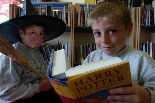 Andrew and Dylan Charlton tuck into the latest Harry Potter arrival at the Central Library in 2003.