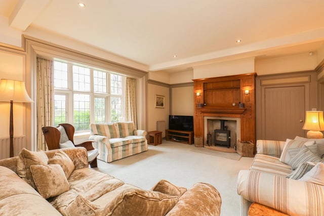 There are four reception rooms including study, music room and formal lounge with wood burning stove.