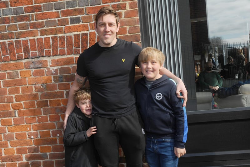 Lee Merrett (36) from Emsworth, with his sons (left) Harry (7) and George (11) all waiting to get their haircut at Ian's Barbers in Park Road, Havant. Picture: Sarah Standing (120421-6457)
