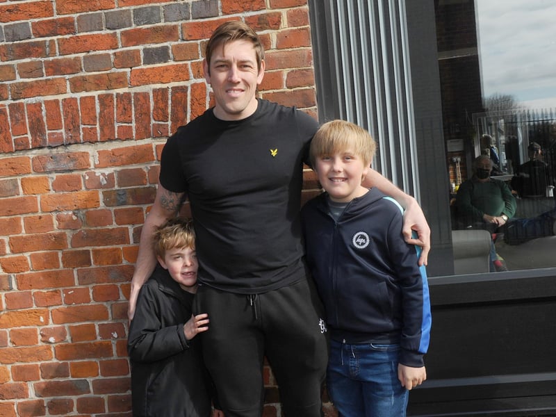 Lee Merrett (36) from Emsworth, with his sons (left) Harry (7) and George (11) all waiting to get their haircut at Ian's Barbers in Park Road, Havant. Picture: Sarah Standing (120421-6457)