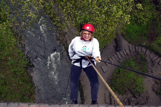Pictured during Sheffield Weston Park Hospital Cancer Appeal annual abseil in 2000 from the viaduct at Miller's  Dale, Derbyshire over the River Wye was fund raiser Carol Fields high above the trees and river as she started her descent.