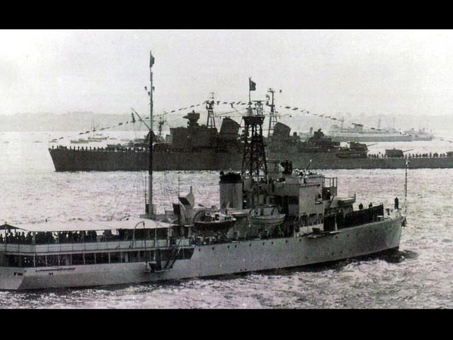 The royal yacht Surprise passing the Swedish cruiser Gota Lejon at the 1953 Spithead coronation fleet review.