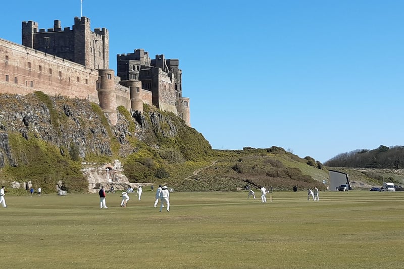 Bamburgh Cricket Club take on Oudle Ramblers against the impressive backdrop of the castle.