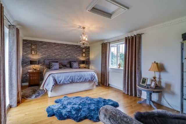 There are four generously sized bedrooms throughout the property, including this impressive master bedroom which boasts its own dressing area, en-suite and double glazed patio doors that open onto a balcony.