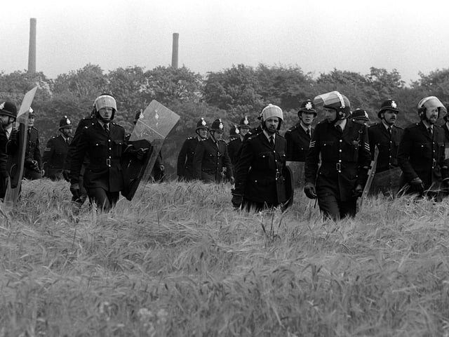 Lines of police moving forward