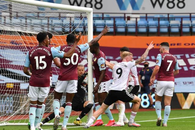 Orjan Nyland of Aston Villa catches the ball over the line as players react to the referee during the Premier League match between Aston Villa and Sheffield United at Villa Park on June 17, 2020 in Birmingham, England. (Photo by Paul Ellis/Pool via Getty Images)