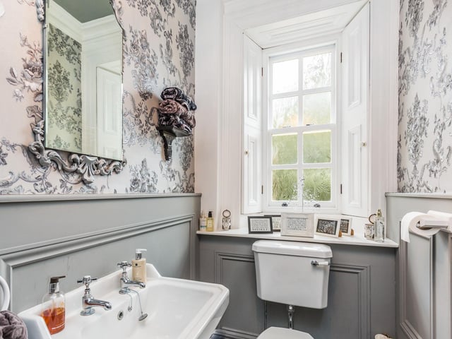 Suite with ornate panelling to the walls and tiled flooring with underfloor heating.
