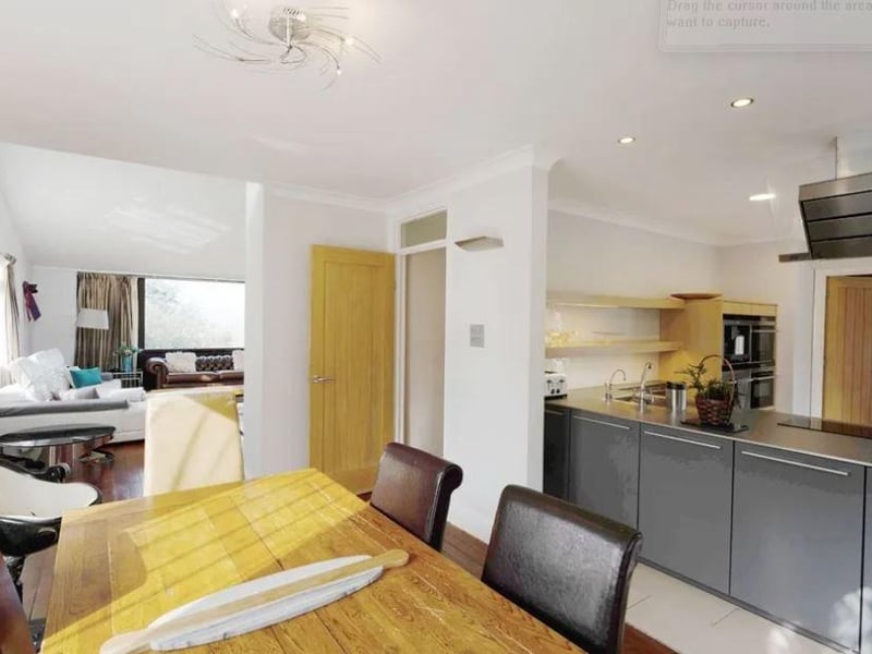 There is a table you can have a meal at in the kitchen.