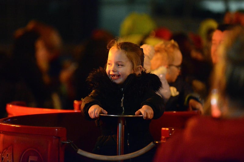 Big smiles from a young visitor enjoying one of the rides at the Christmas lights switch-on 2022