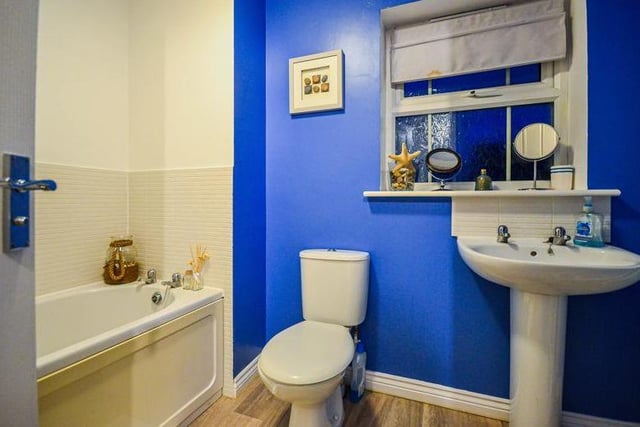 The family bathroom features a bath, low-flush WC and wash hand basin. The room is clean and practical.