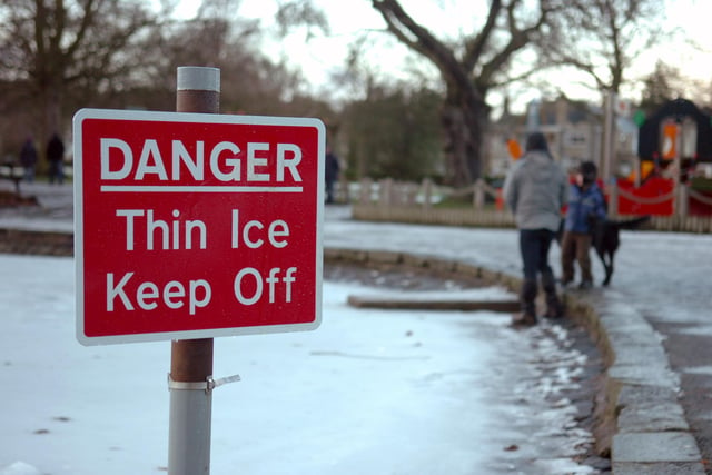 Warning signs were put up as people brave the surface of the frozen pond in Beveridge Park, Kirkcaldy