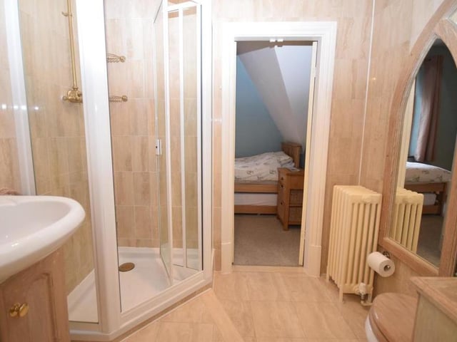 The second floor has its own shower room, which comprises a fitted shower cubicle, wash basin in a vanity unit and low-flush WC. The floor and walls are decorated with modern tiling.