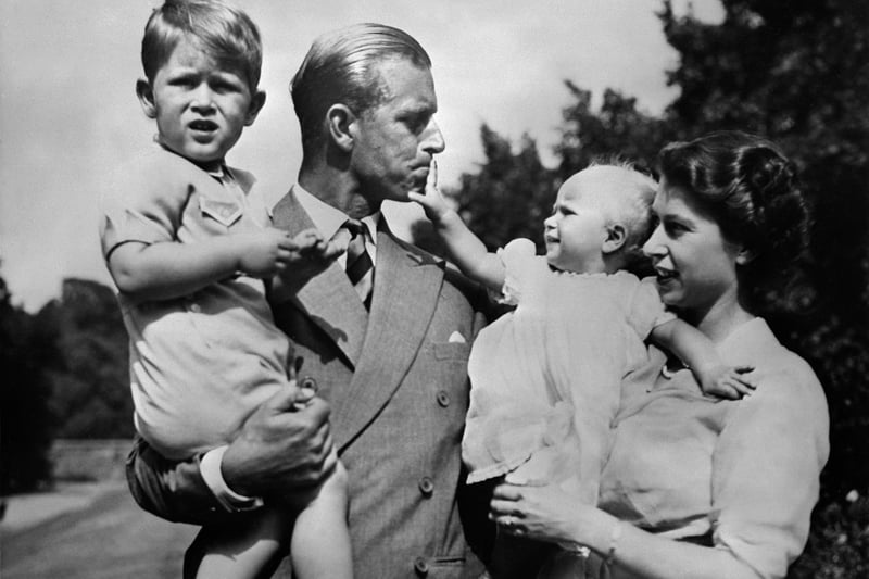 Royal British couple, Queen Elizabeth II, and her husband Philip, Duke of Edinburgh, with their two children, Charles, Prince of Wales (L) and Princess Anne (R), circa 1951.