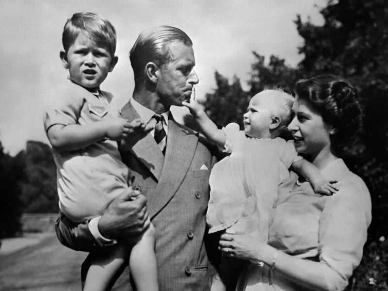 Royal British couple, Queen Elizabeth II, and her husband Philip, Duke of Edinburgh, with their two children, Charles, Prince of Wales (L) and Princess Anne (R), circa 1951.