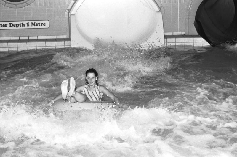 The new water flume opens at the Commonwealth pool in Edinburgh, September 1988. A young customer enjoys the ride.