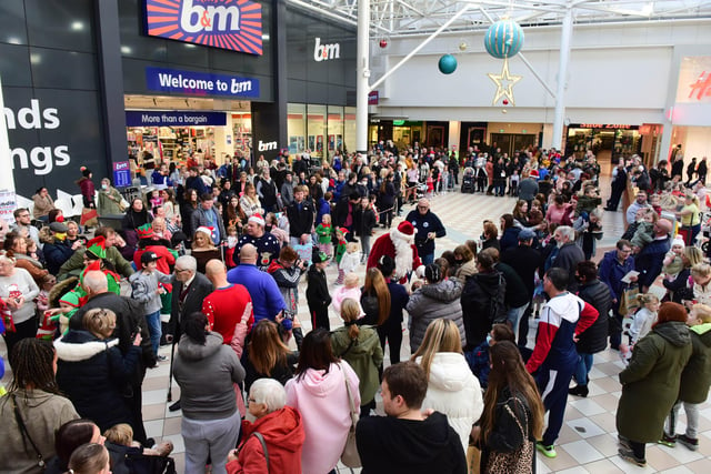 Crowds welcome Santa Claus to Middleton Grange Shopping Centre.