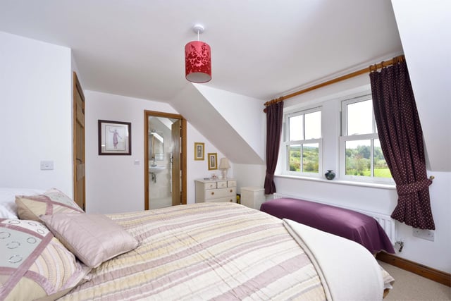 The master bedroom benefits from an en-suite and views over the gardens and surrounding countryside