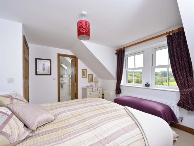 The master bedroom benefits from an en-suite and views over the gardens and surrounding countryside