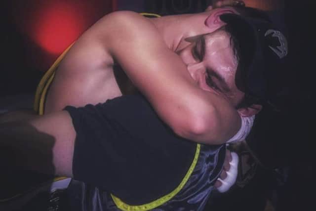 Peter hugging his son, Tyler after the fight. Picture by Peter Hourihan.