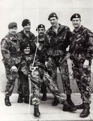 Members of the Royal Marines Commando display team at the Services Display in Norfolk Park, July 1980. They gave lunchtime crowds a thrill when they absailed down the side of the Trustee Savings Bank behind Norfolk Street, Sheffield