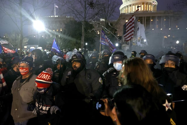 Police officers in riot gear move  protesters who are gathering at the U.S. Capitol Building on January 06, 2021 in Washington, DC. Pro-Trump protesters entered the U.S. Capitol building after mass demonstrations in the nation's capital during a joint session Congress to ratify President-elect Joe Biden's 306-232 Electoral College win over President Donald Trump. (Photo by Tasos Katopodis/Getty Images)