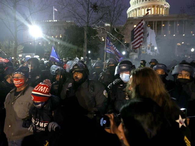 Police officers in riot gear move protesters who are gathering at the U.S. Capitol Building on January 06, 2021 in Washington, DC. Pro-Trump protesters entered the U.S. Capitol building after mass demonstrations in the nation's capital during a joint session Congress to ratify President-elect Joe Biden's 306-232 Electoral College win over President Donald Trump. (Photo by Tasos Katopodis/Getty Images)