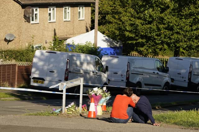The father to some of the victims leaves flowers at the scene in Chandos Crescent, Killamarsh, near Sheffield, where four people were found dead at a house on Sunday. Derbyshire Police said a man is in police custody and they are not looking for anyone else in connection with the deaths. Picture date: Monday September 20, 2021. PA Photo. See PA story POLICE Killamarsh. Photo credit should read: Danny Lawson/PA Wire 