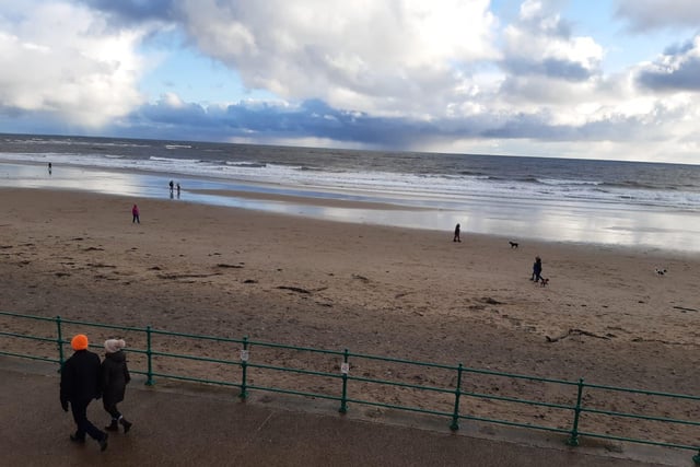 A small number of people, particularly dog walkers, on the beach at Roker.