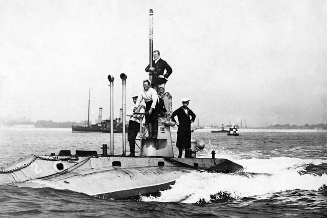 Officers and crew stand on deck around the conning tower of the second Royal Navy Holland-class submarine HMS Holland 2 on patrol entering Fort Blockhouse submarine base near Gosport circa 1905 off Gosport, United Kingdom.  (Photo by Paul Thompson/FPG/Getty Images)