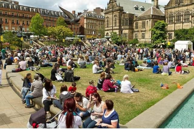 People enjoying the sun in the city centre.